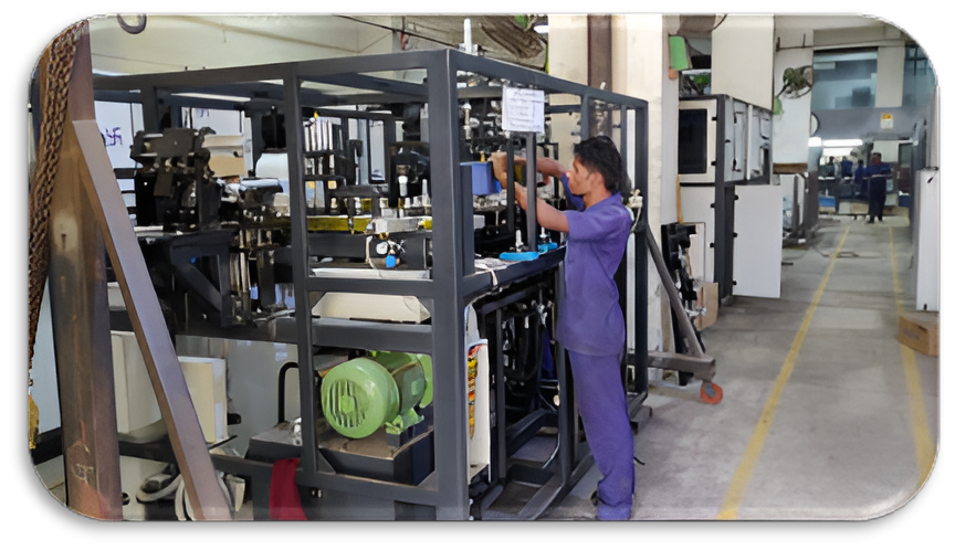 Engineers collaborating on industrial machine building at Global PET Industries